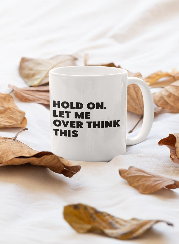 A stylish 11oz ceramic mug with a glossy finish featuring the phrase 'Hold On Let Me Overthink This' in a fun font.