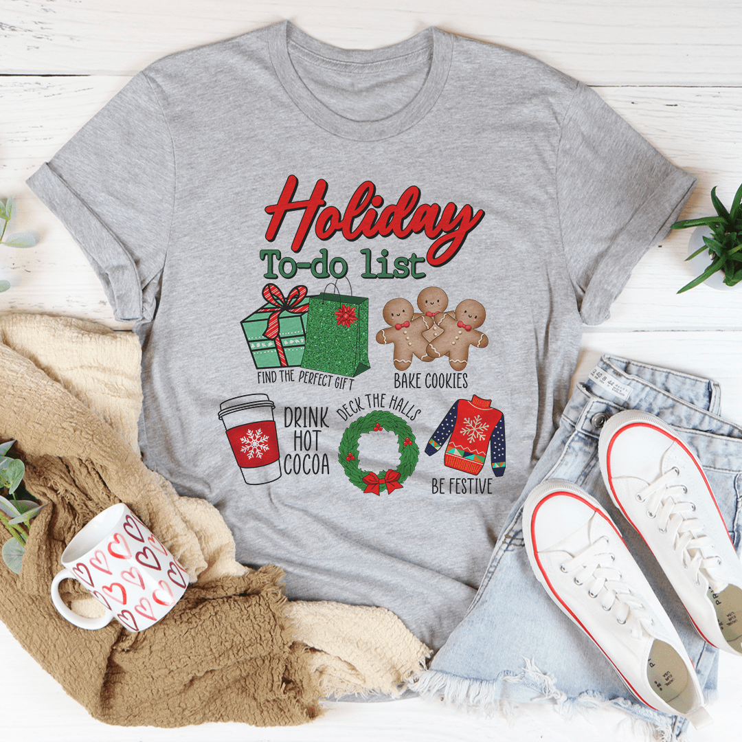 A festive Holiday To Do List tee featuring vibrant Christmas-themed digital print on soft cotton fabric, perfect for holiday celebrations.