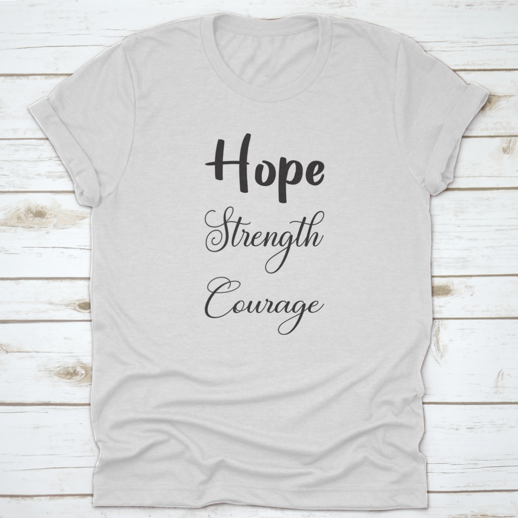 A trendy T-shirt featuring the inspirational quote 'Hope Strength Courage' in stylish lettering, made from soft cotton fabric.