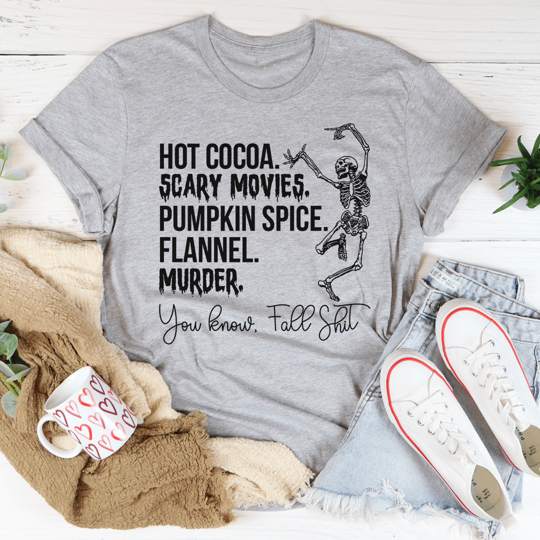 A cozy t-shirt featuring a fun design of hot cocoa, scary movies, and pumpkin spice, perfect for fall.