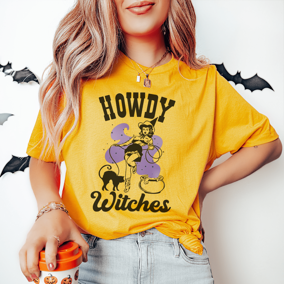 A stylish Howdy Witches Tee featuring vibrant Halloween-themed graphics, made from 100% soft cotton for comfort.