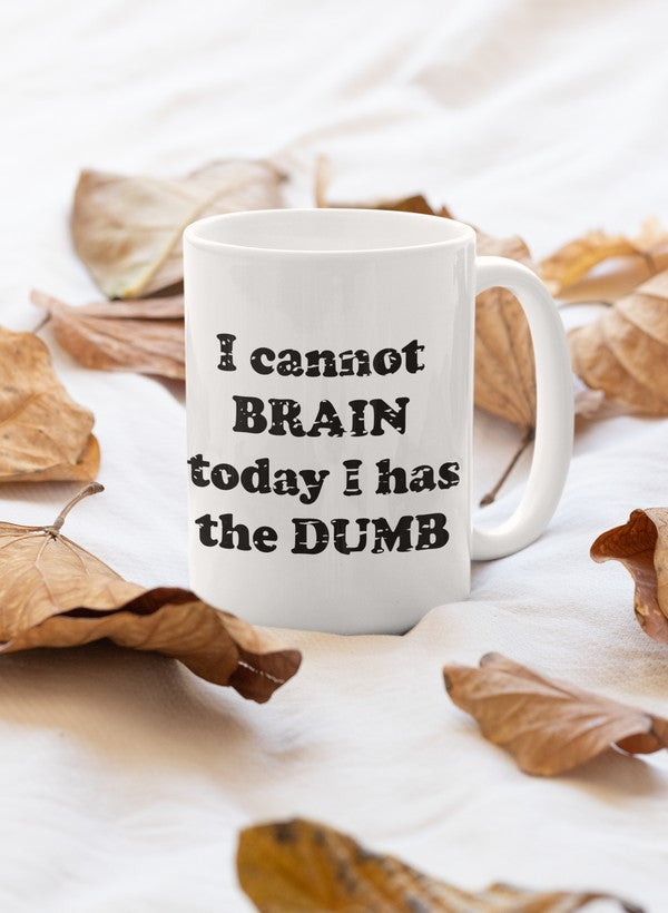 A humorous ceramic mug with the phrase 'I Cannot Brain Today I Has The Dumb' printed on it, featuring a glossy finish and sturdy handle.