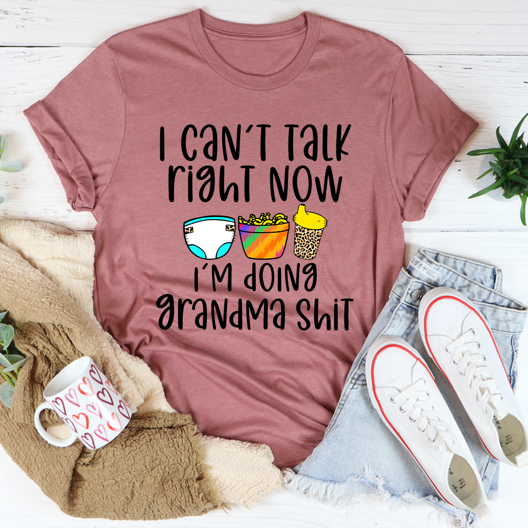 A comfortable and stylish t-shirt featuring the phrase 'I Can't Talk Right Now I'm Doing Grandma Stuff', made from soft cotton.
