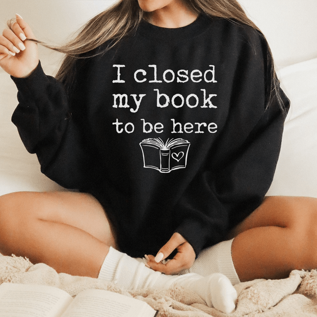 Cozy 'I Closed My Book To Be Here' sweats featuring unique designs by top artists, made from a soft cotton/poly fleece blend.