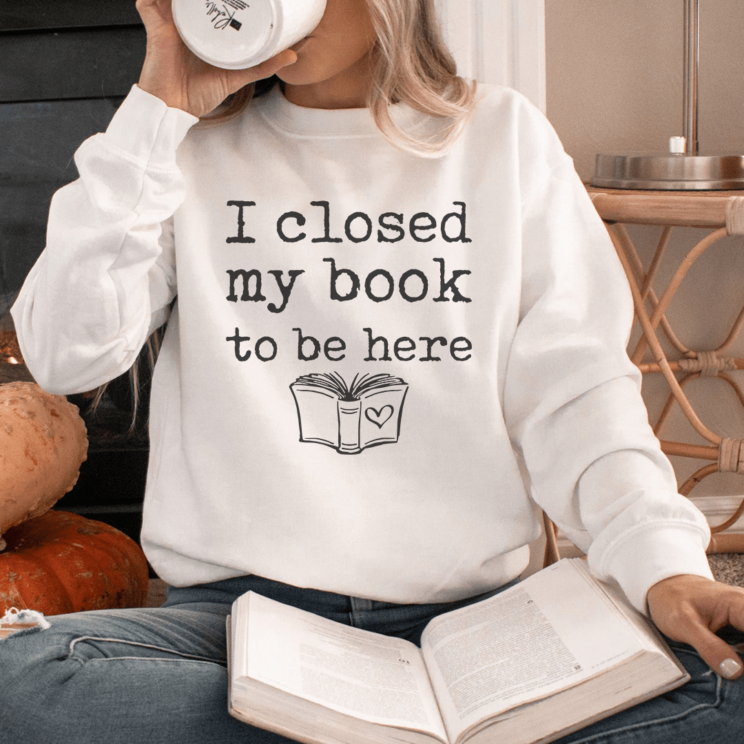Cozy 'I Closed My Book To Be Here' sweats featuring unique designs by top artists, made from a soft cotton/poly fleece blend.