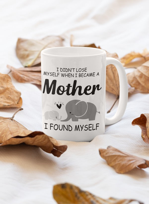 A stylish 11oz ceramic mug with a glossy finish featuring the quote 'I Didn't Lose Myself When I Became A Mother I Found Myself' on the front.
