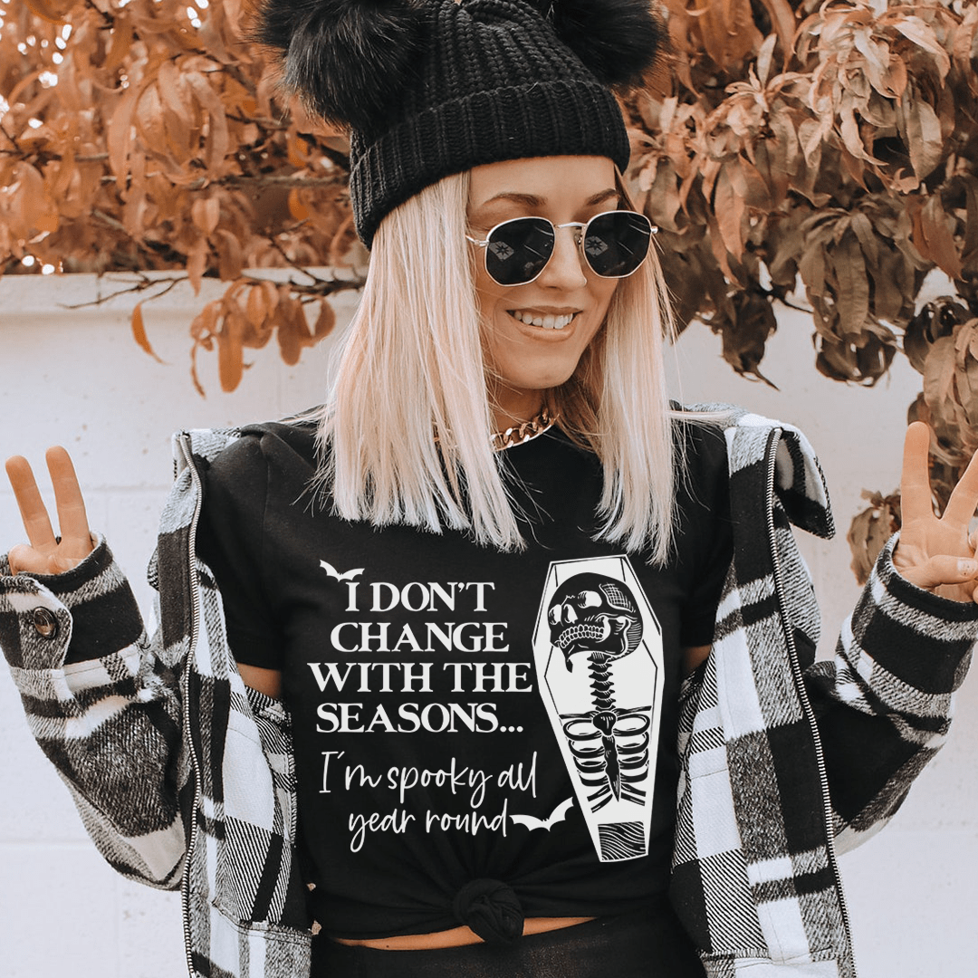 I Don't Change With The Seasons Tee featuring a vibrant Halloween design, made from 100% soft cotton, perfect for festive occasions.