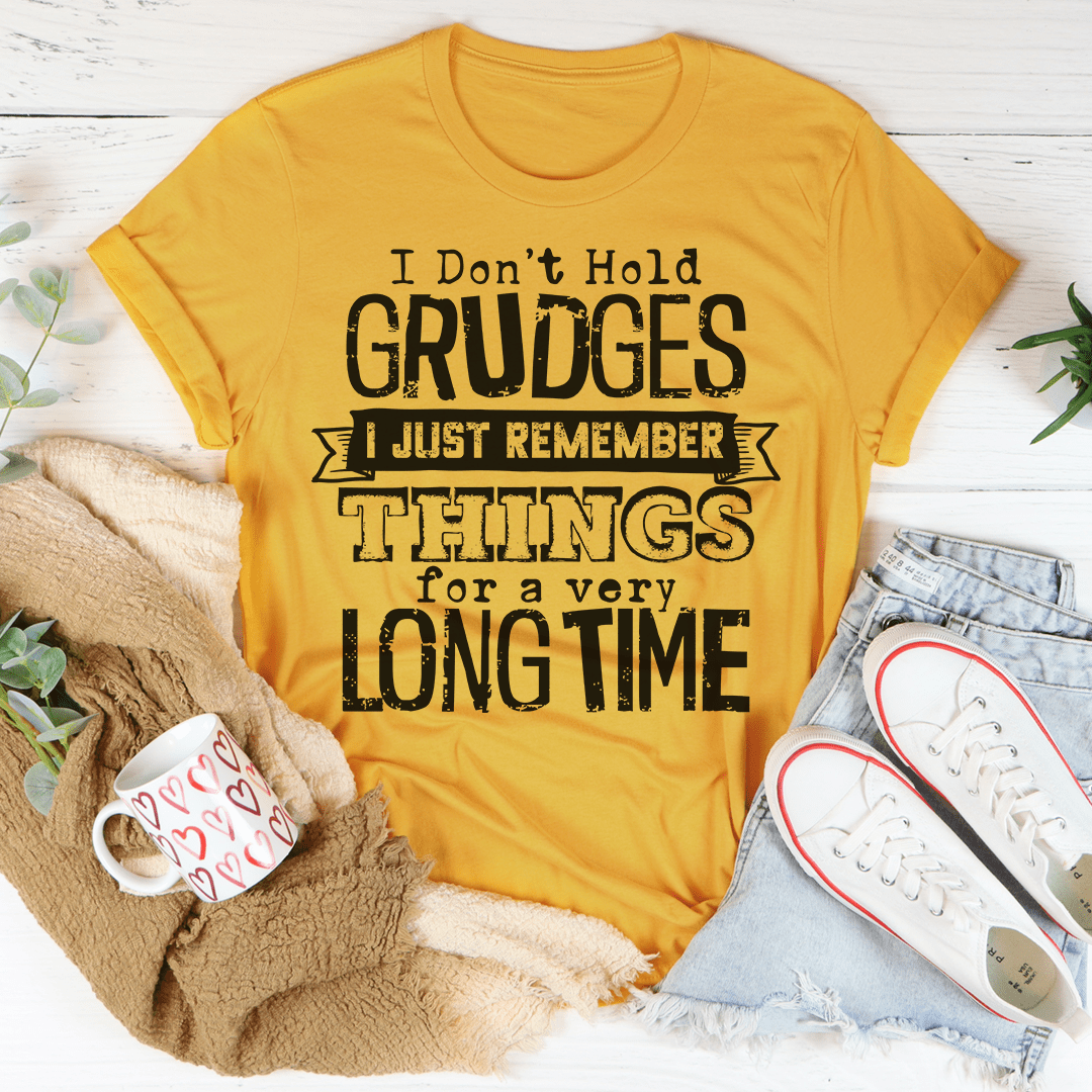 A comfortable and stylish t-shirt featuring the phrase 'I Don't Hold Grudges I Just Remember Things For A Very Long Time', made from soft cotton.