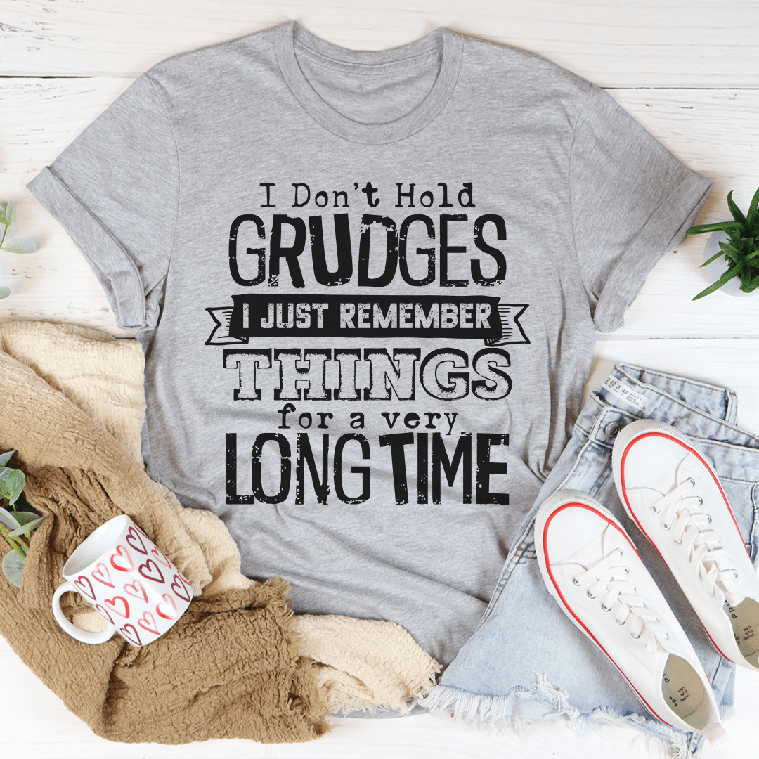 A comfortable and stylish t-shirt featuring the phrase 'I Don't Hold Grudges I Just Remember Things For A Very Long Time', made from soft cotton.