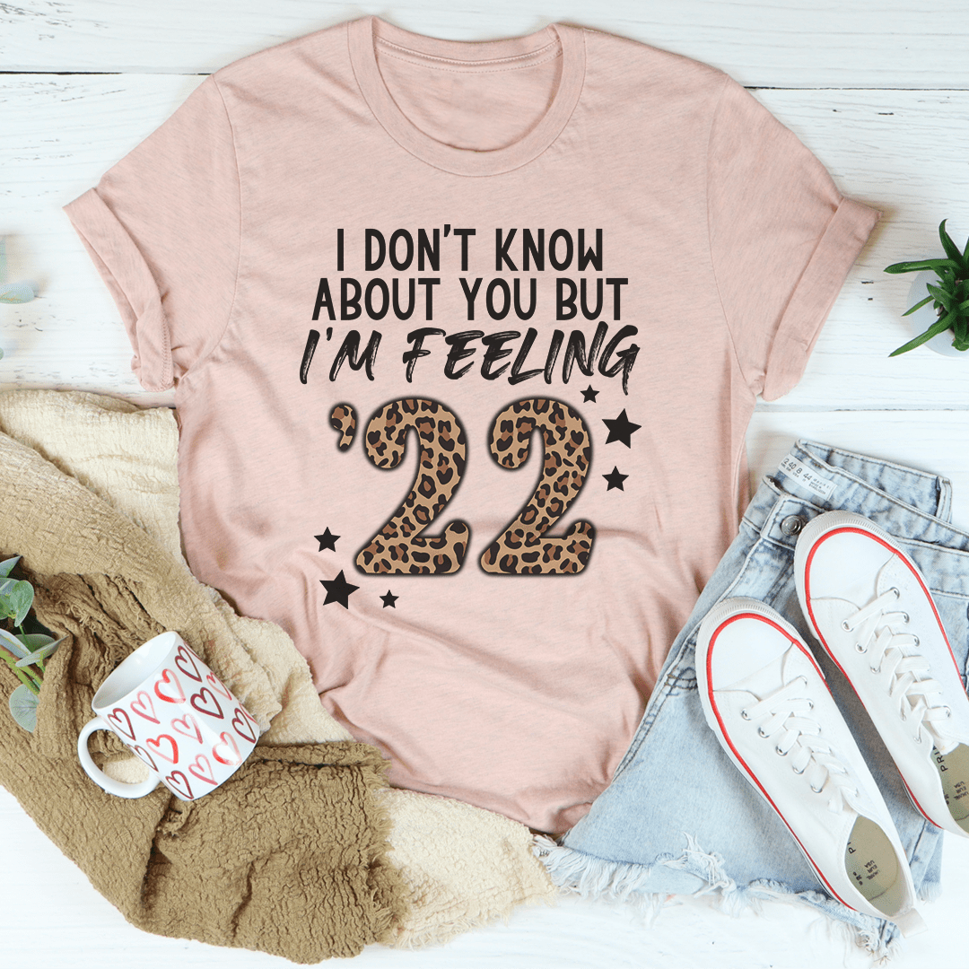A festive 'I Don't Know About You But I'm Feeling '22 Tee, made from soft cotton, featuring a vibrant holiday-themed print.