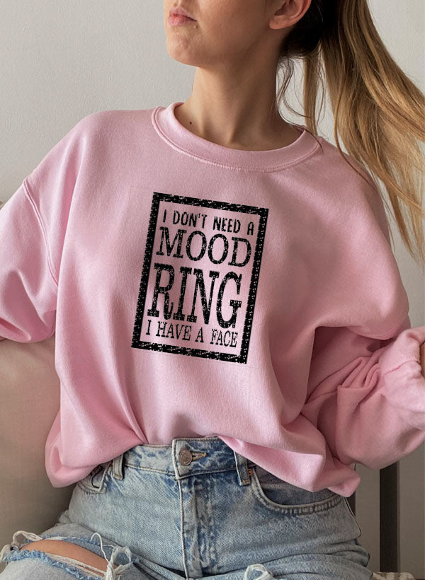 A cozy sweatshirt featuring the phrase 'I Don't Need A Mood Ring I HAVE A FACE' in a stylish font, perfect for casual wear.
