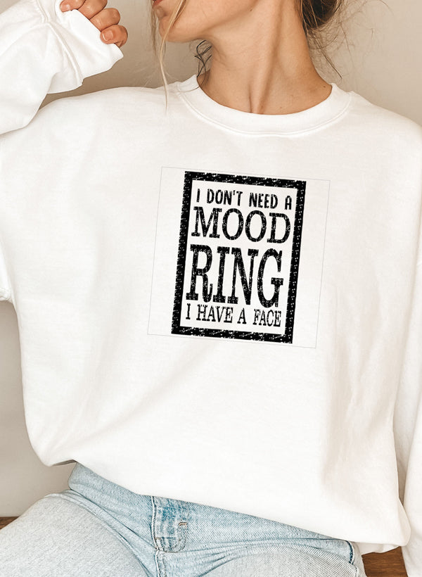 A cozy sweatshirt featuring the phrase 'I Don't Need A Mood Ring I HAVE A FACE' in a stylish font, perfect for casual wear.