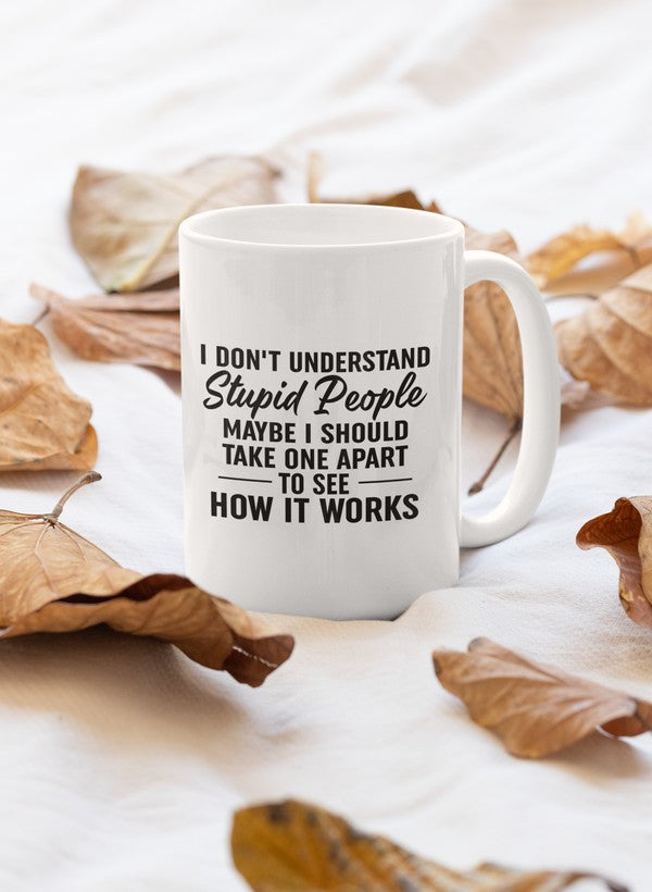 A humorous ceramic mug with the phrase 'I Don't Understand Stupid People' printed on it, featuring a glossy finish and sturdy handle.