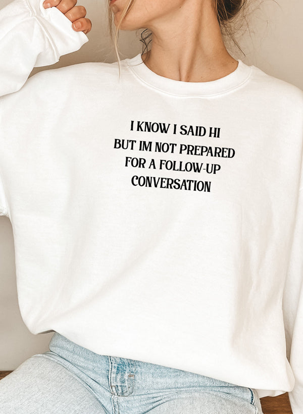 Cozy hoodie featuring unique design with text 'I Know I Said Hi But I'm Not Prepared For A Follow-Up Conversation', made from cotton/poly fleece blend.