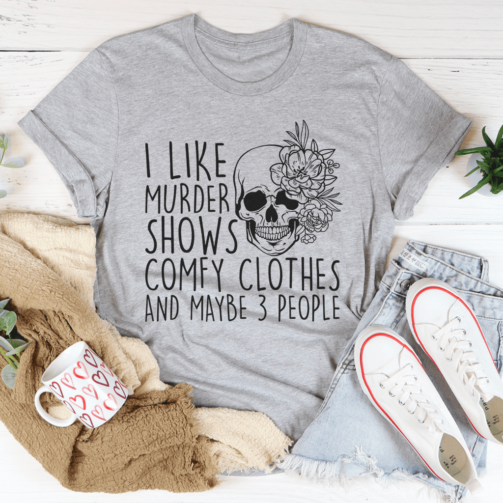 A comfortable t-shirt featuring the phrase 'I Like Murder Shows Comfy Clothes And Maybe 3 People' printed on it, showcasing its soft fabric and durable stitching.