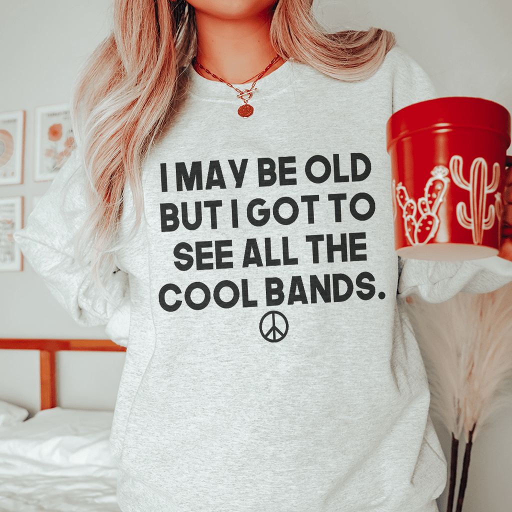 I May Be Old But I Got To See All The Cool Bands Sweatshirt T-Shirt in various colors, showcasing its soft fabric and stylish design.