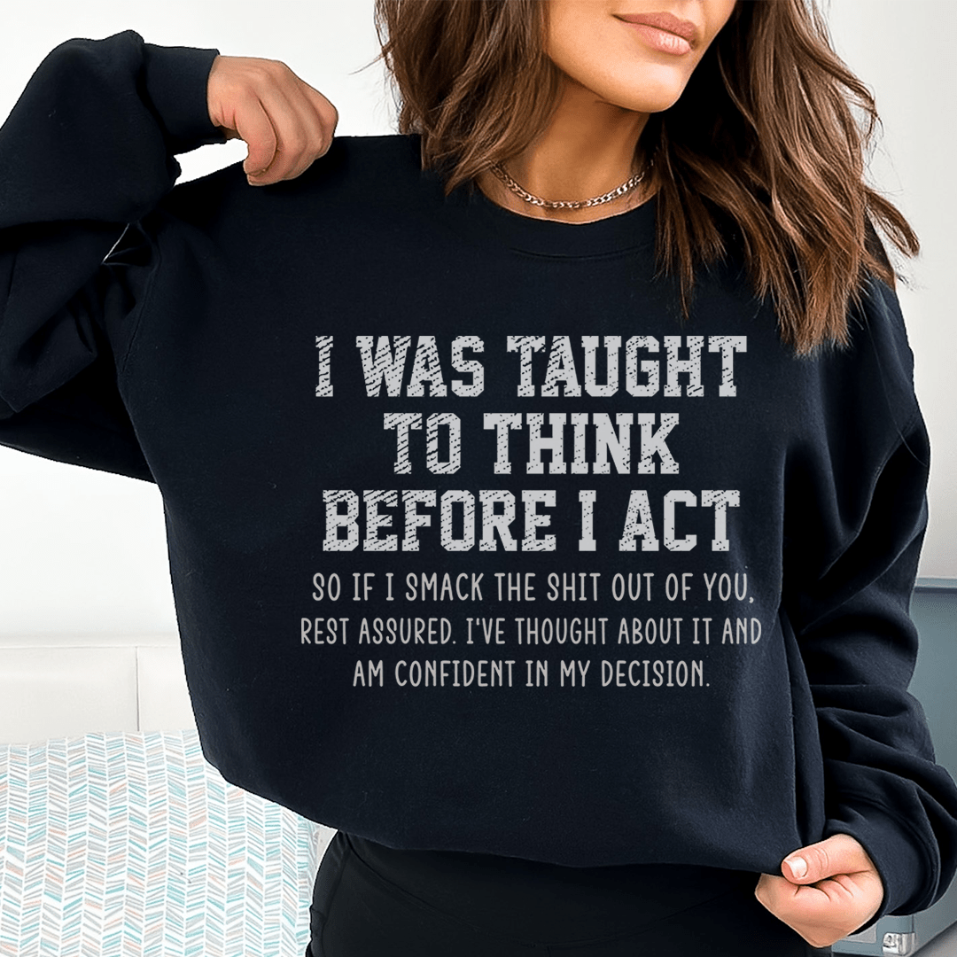 A cozy hoodie featuring the phrase 'I Was Taught To Think Before I Act', designed by top artists, showcasing a stylish and comfortable fit.