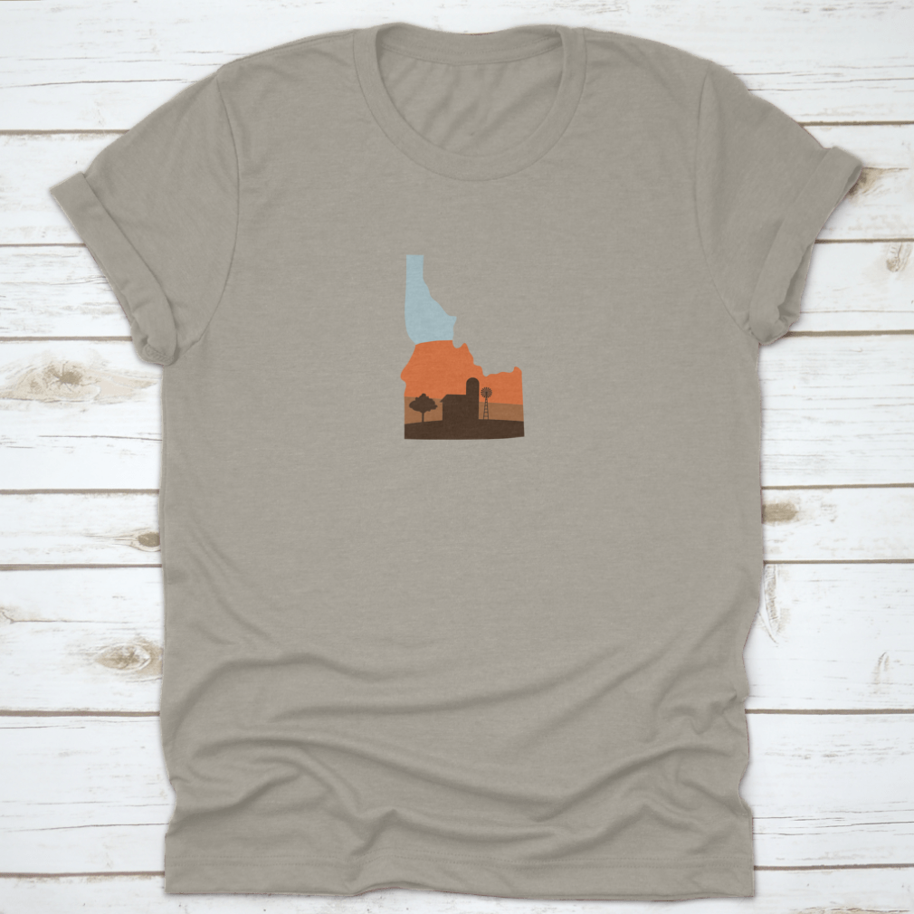 Idaho state shape design featuring a farm at sunset with a windmill and barn, showcasing vibrant colors.