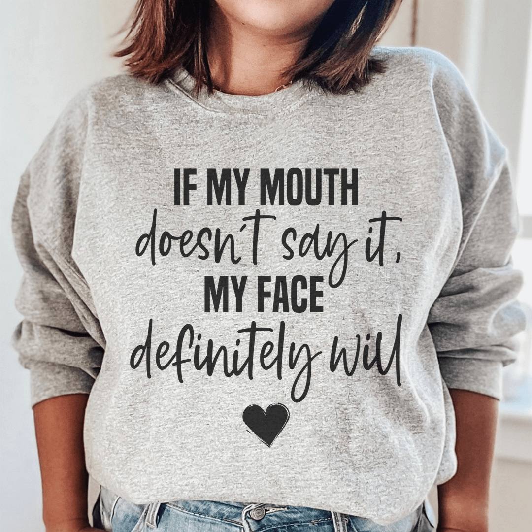 Cozy sweats featuring the phrase 'If My Mouth Doesn't Say It My Face Definitely Will', designed by top artists, showcasing a stylish and comfortable fit.