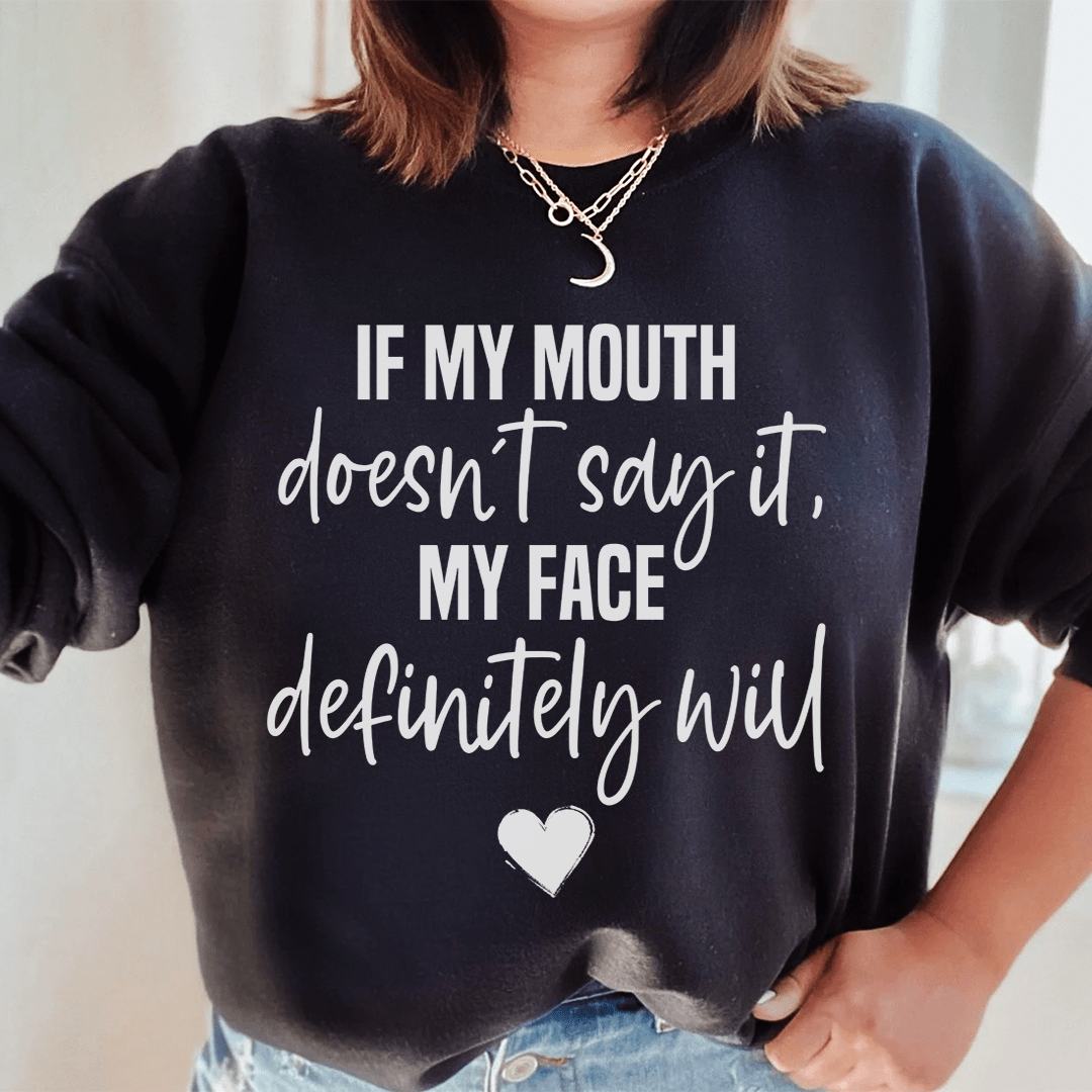 Cozy sweats featuring the phrase 'If My Mouth Doesn't Say It My Face Definitely Will', designed by top artists, showcasing a stylish and comfortable fit.