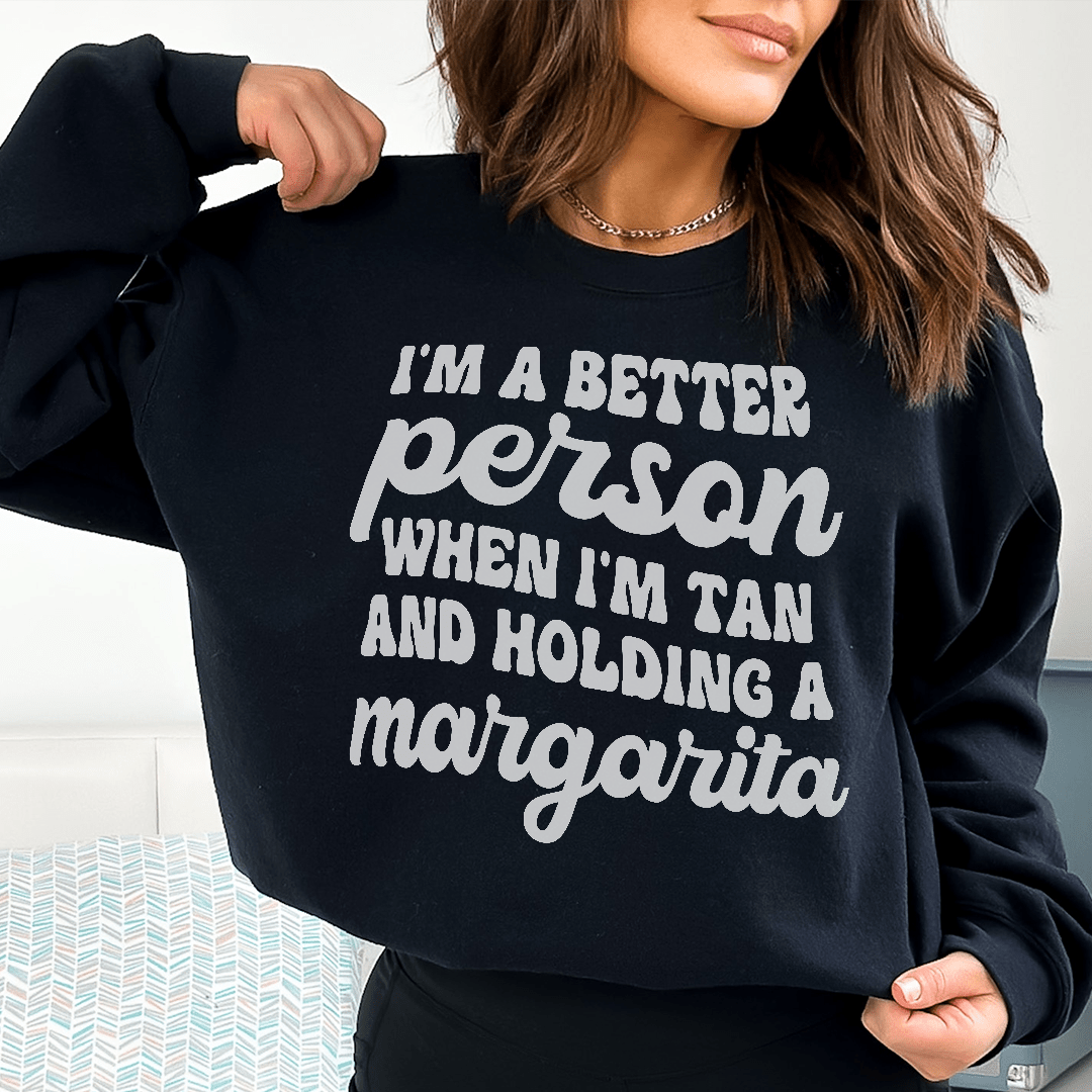 A stylish hoodie featuring the phrase 'I'm A Better Person When I'm Tan', designed by top artists, made from cozy cotton/poly fleece blend.
