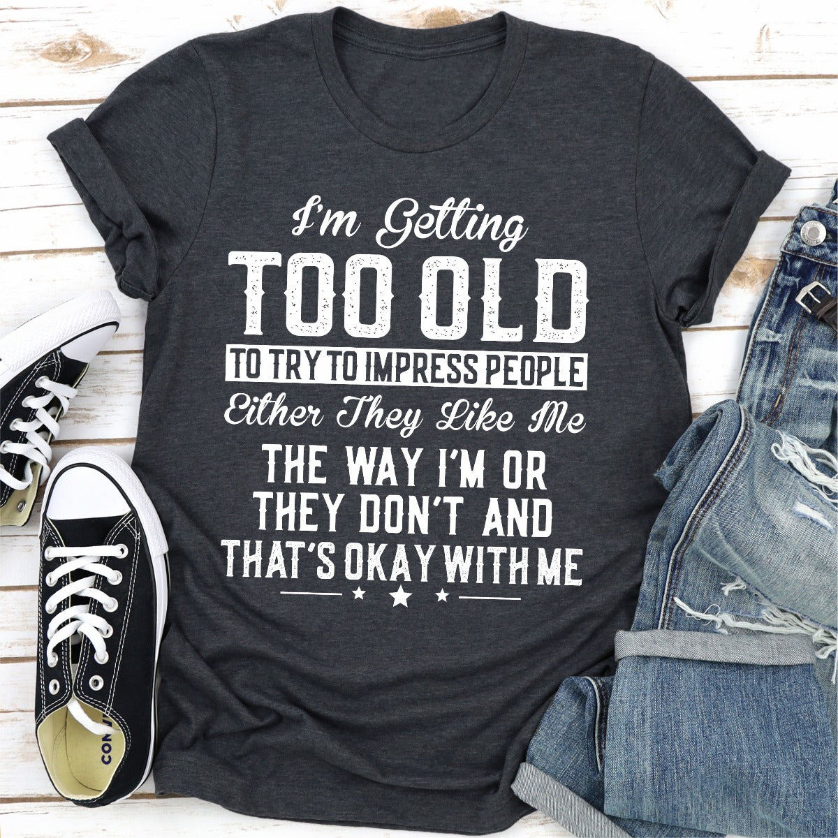 I'm Getting Too Old To Try To Impress People T-Shirt displayed on a mannequin, showcasing its soft fabric and double-stitched neckline.