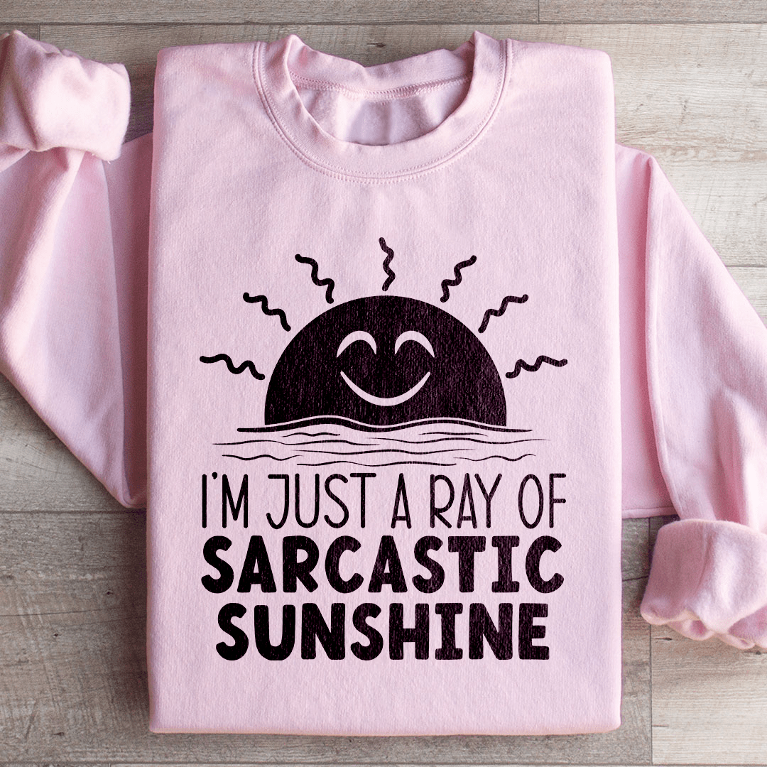 A cozy sweatshirt featuring the phrase 'I'm Just A Ray Of Sarcastic Sunshine' in a stylish font, perfect for casual wear.
