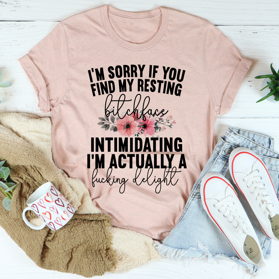 A humorous t-shirt featuring the phrase 'I'm Sorry If You Find My Resting Face Intimidating', made from soft cotton with double stitching.
