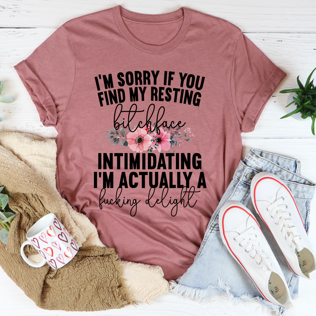A humorous t-shirt featuring the phrase 'I'm Sorry If You Find My Resting Face Intimidating', made from soft cotton with double stitching.