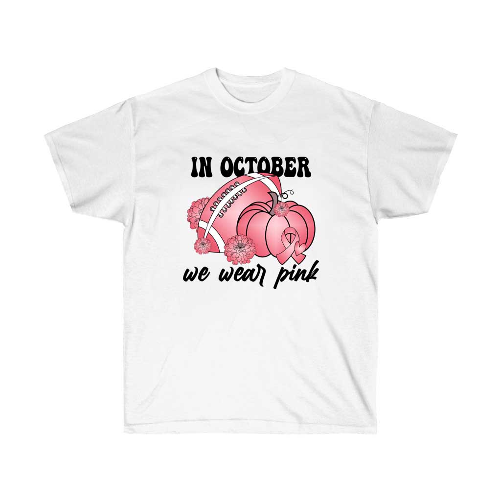 A unisex pink t-shirt with the text 'In October We Wear Pink' for Breast Cancer Awareness, made from 100% soft cotton.