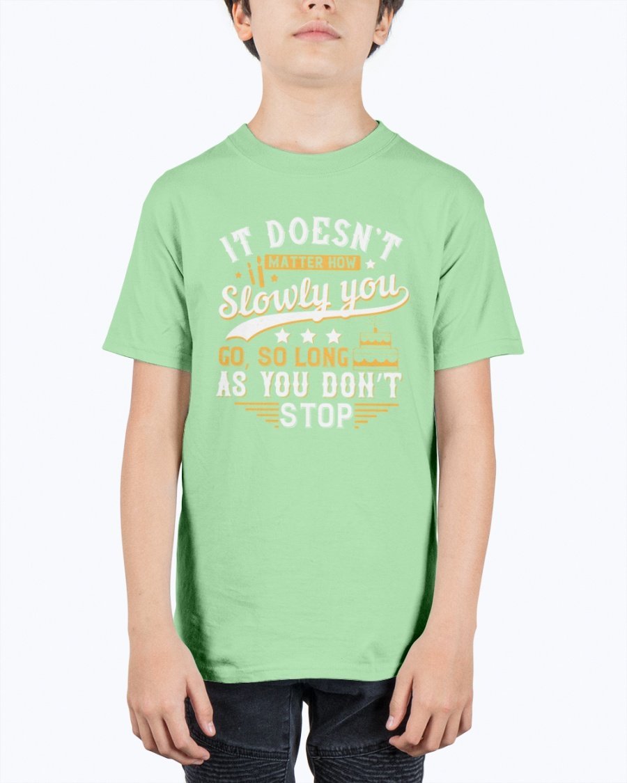 A motivational youth t-shirt featuring the quote 'It doesn’t matter how slowly you go, so long as you don’t stop' in a stylish design.