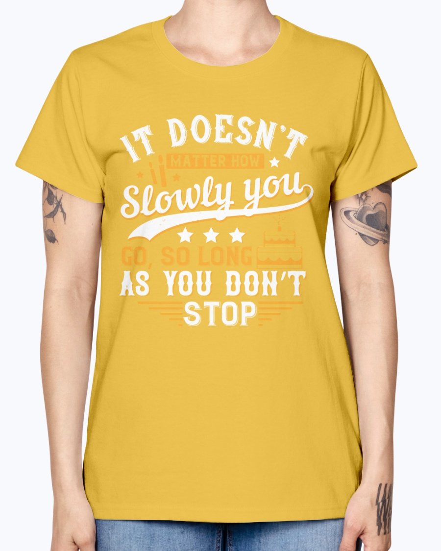 A stylish Missy T-Shirt featuring the motivational quote 'It doesn’t matter how slowly you go, so long as you don’t stop' in a soft cotton blend.