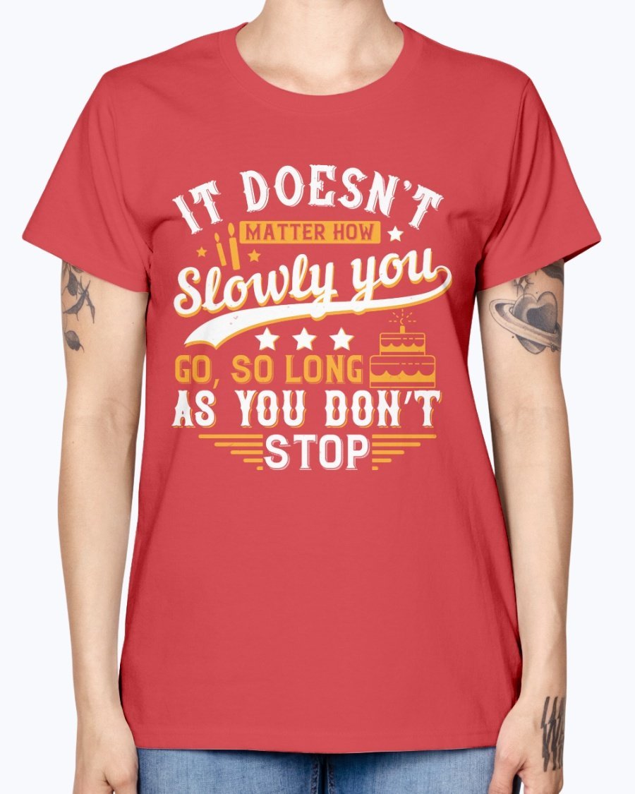 A stylish Missy T-Shirt featuring the motivational quote 'It doesn’t matter how slowly you go, so long as you don’t stop' in a soft cotton blend.