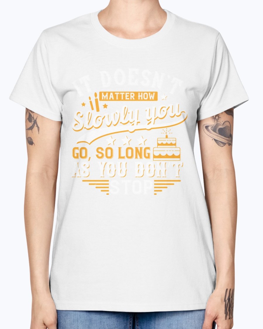 A stylish Missy T-Shirt featuring the motivational quote 'It doesn’t matter how slowly you go, so long as you don’t stop' in a soft cotton blend.