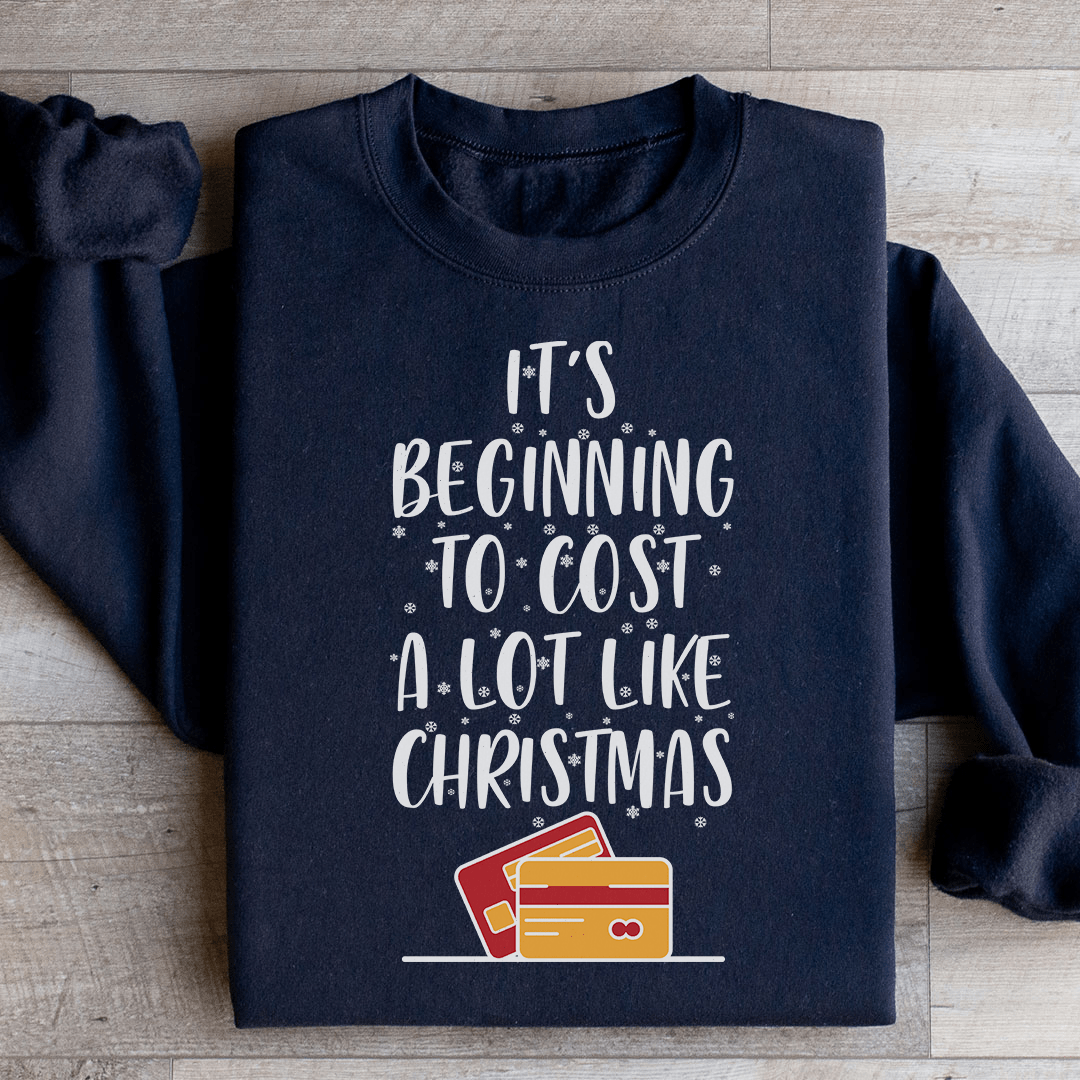 A festive sweatshirt featuring the phrase 'It's Beginning To Cost A Lot Like Christmas' in vibrant colors, made from soft cotton.