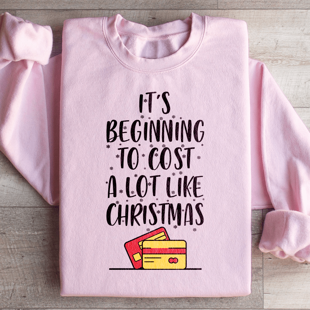 A festive sweatshirt featuring the phrase 'It's Beginning To Cost A Lot Like Christmas' in vibrant colors, made from soft cotton.