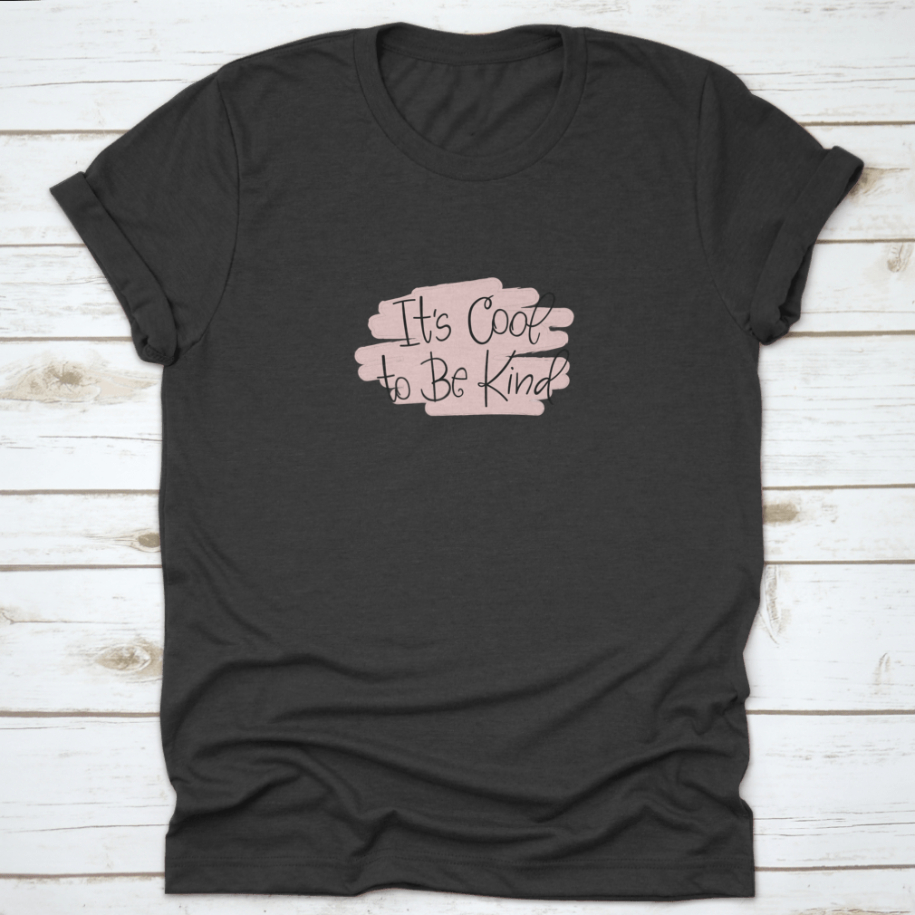A soft cotton T-shirt featuring the motivational quote 'It's Cool To Be Kind' in a stylish font, perfect for spreading positivity.