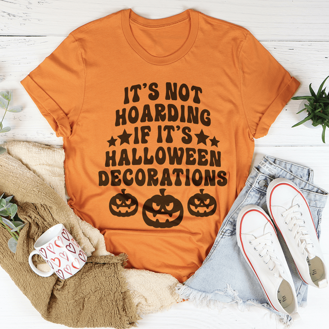 A comfortable Halloween-themed tee featuring the phrase 'It's Not Hoarding If It's Halloween Decorations' printed in vibrant colors.