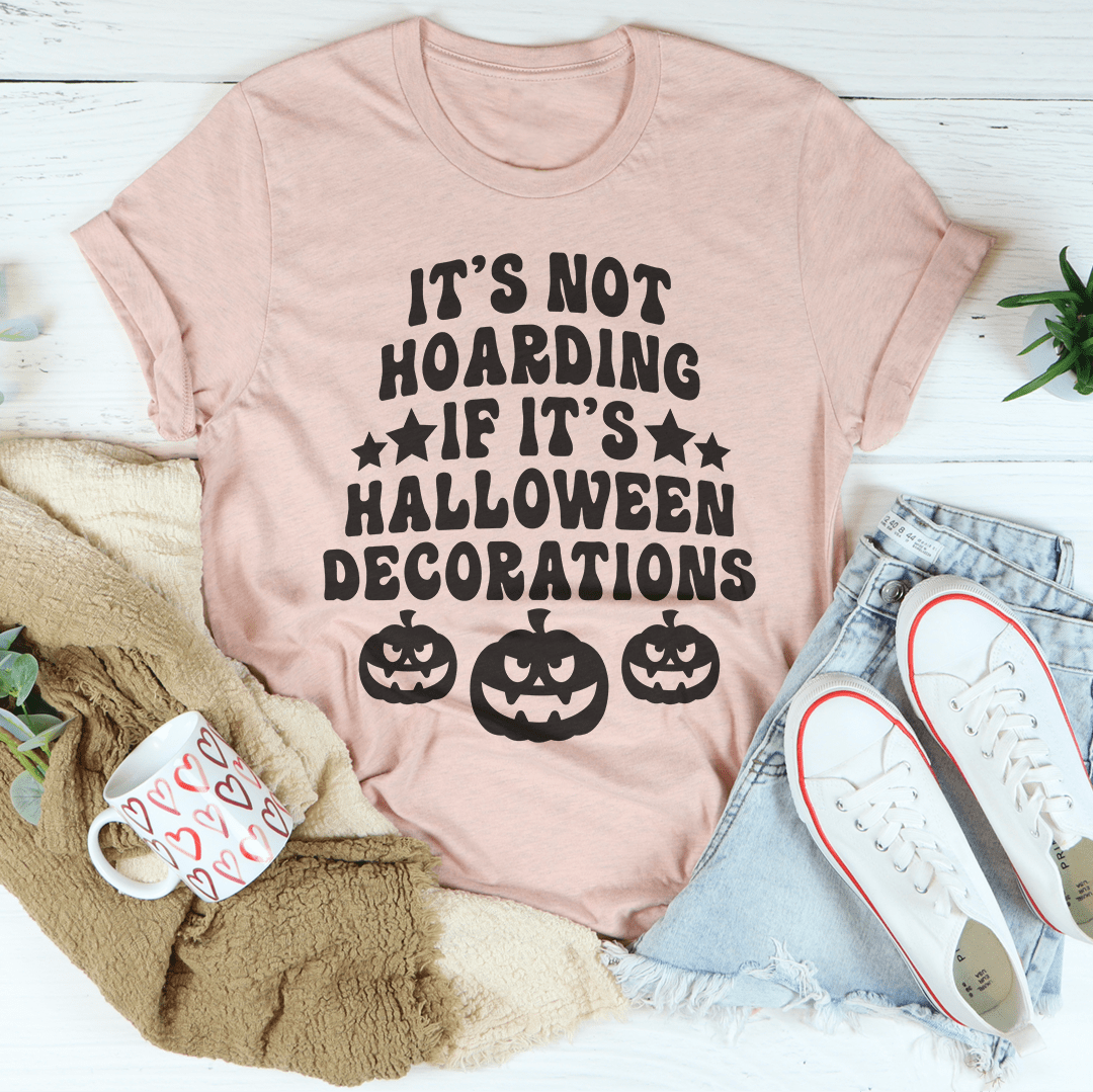 A comfortable Halloween-themed tee featuring the phrase 'It's Not Hoarding If It's Halloween Decorations' printed in vibrant colors.