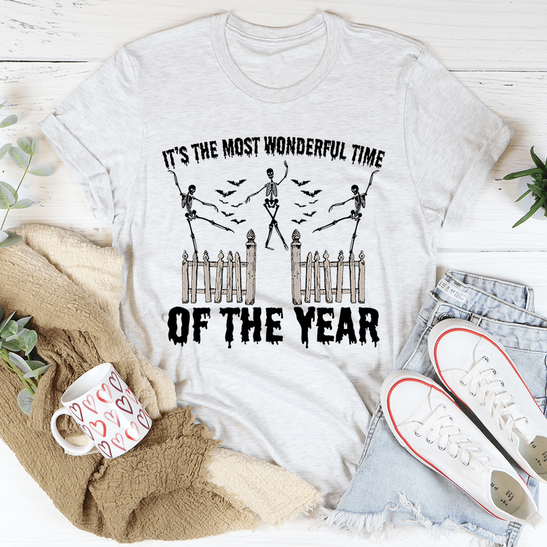A festive Halloween tee featuring the phrase 'It's The Most Wonderful Time Of The Year' printed in vibrant colors on soft cotton fabric.