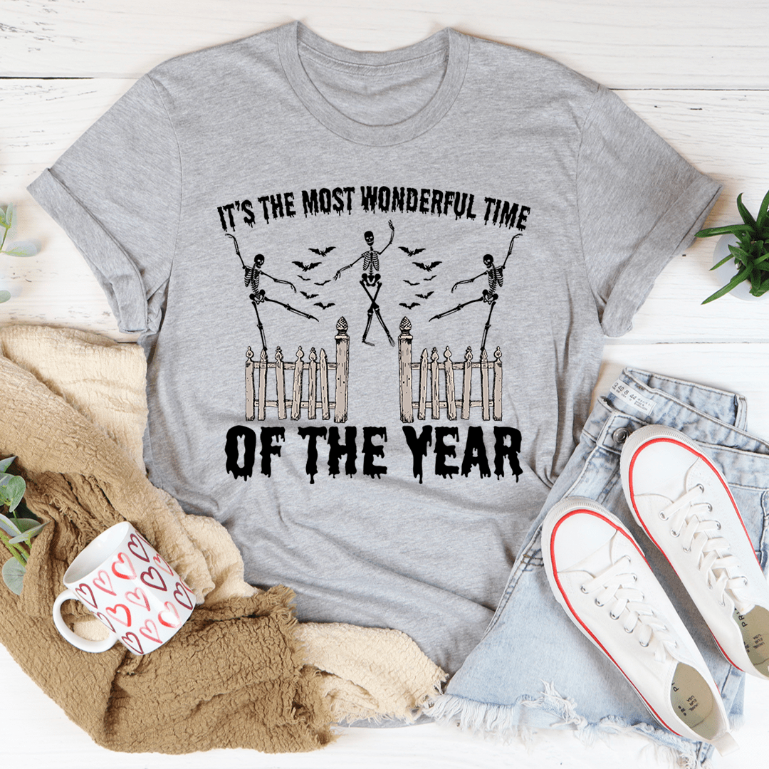 A festive Halloween tee featuring the phrase 'It's The Most Wonderful Time Of The Year' printed in vibrant colors on soft cotton fabric.