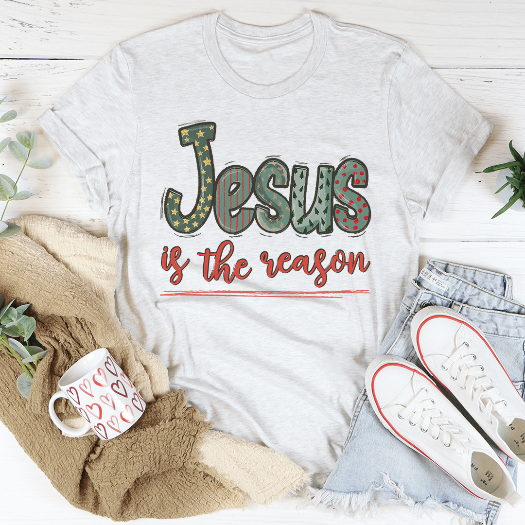A festive Jesus Is The Reason Tee made from 100% soft cotton, featuring a vibrant digitally printed design celebrating Christmas.
