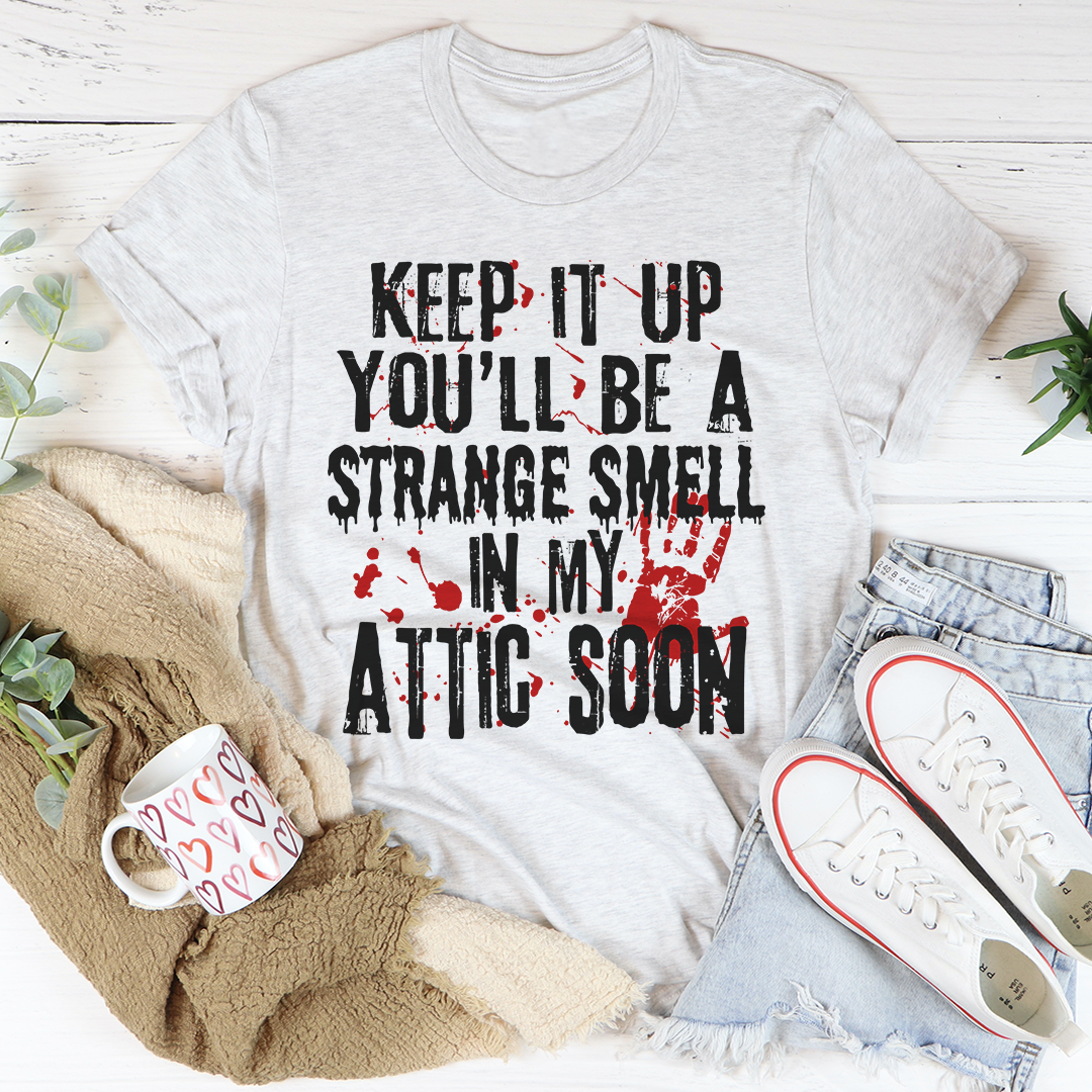 Keep It Up And You'll Be A Strange Smell In The Attic Soon T-Shirt displayed on a mannequin, showcasing its soft cotton fabric and stylish design.