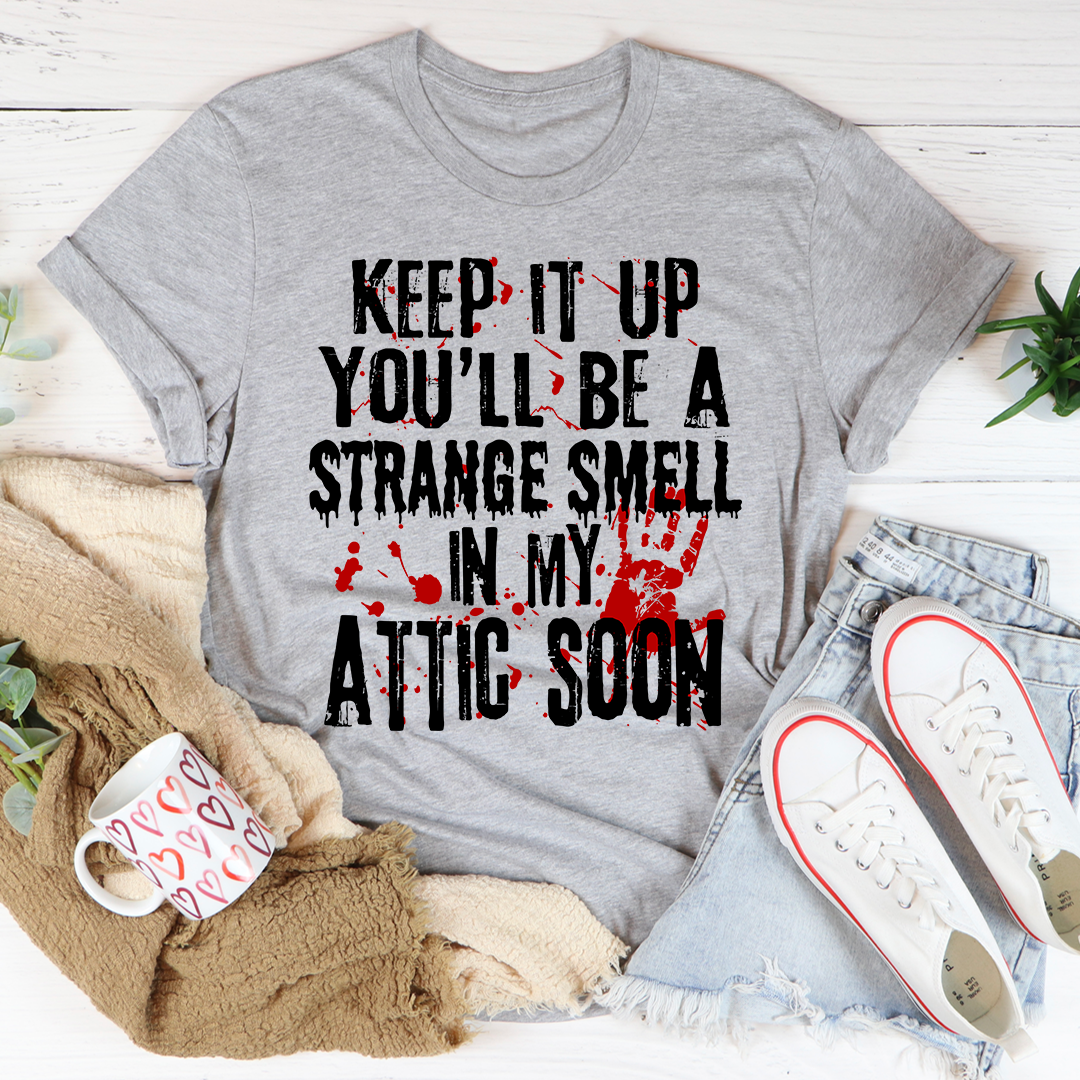 Keep It Up And You'll Be A Strange Smell In The Attic Soon T-Shirt displayed on a mannequin, showcasing its soft cotton fabric and stylish design.