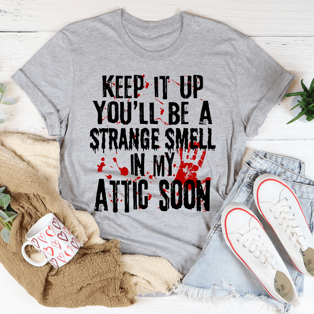 Keep It Up And You'll Be A Strange Smell In The Attic Soon T-Shirt displayed on a mannequin, showcasing its soft cotton fabric and vibrant print.