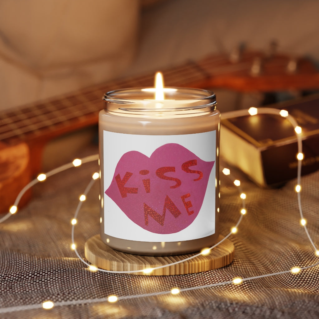 Kiss Me Scented Candle in a glass container, featuring a permanent label, showcasing its warm Cinnamon Stick and Vanilla fragrances.