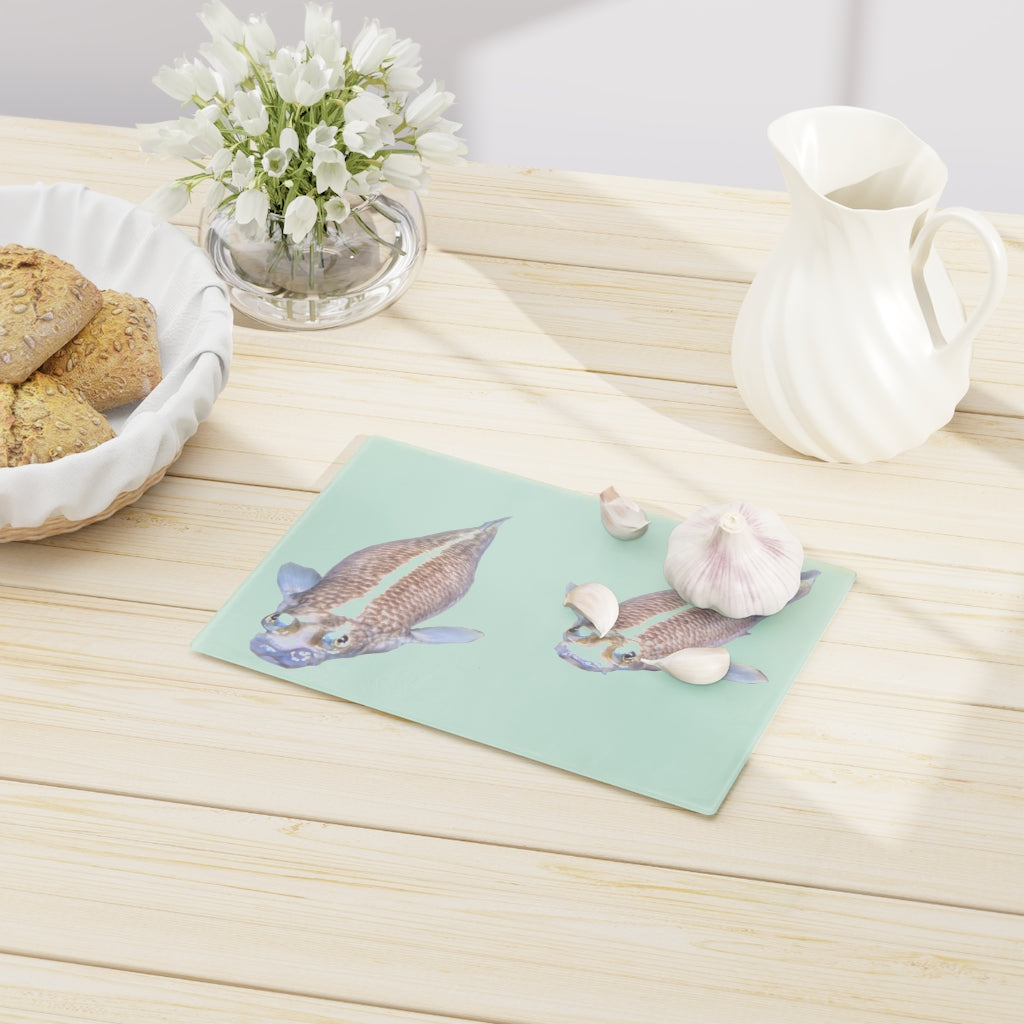 A beautifully designed Koi Fish Cutting Board made of tempered glass, featuring a unique Koi fish pattern and rubber dots for stability.