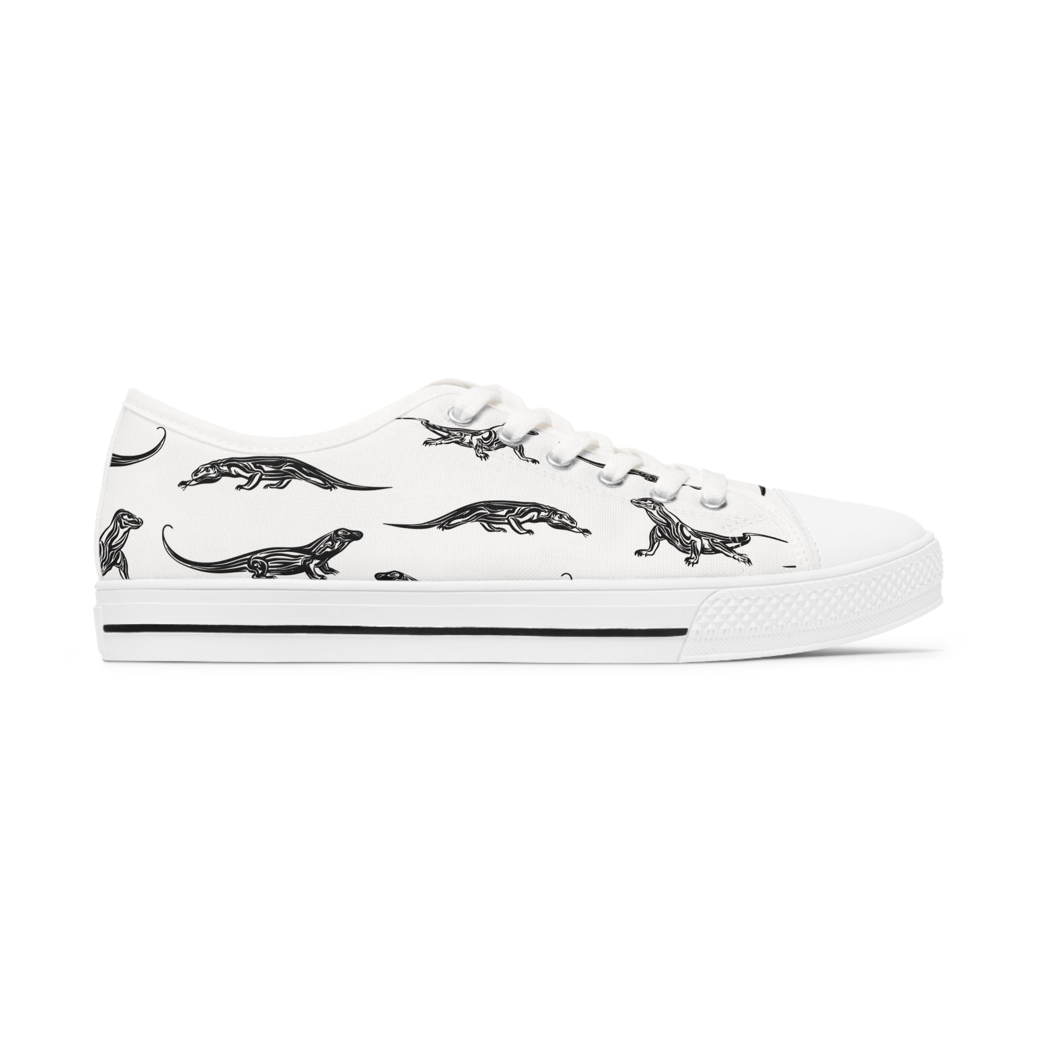 A pair of Komodo Dragon Women's Low Top Sneakers in black and white, showcasing breathable polyester canvas and stylish silver metal eyelets.