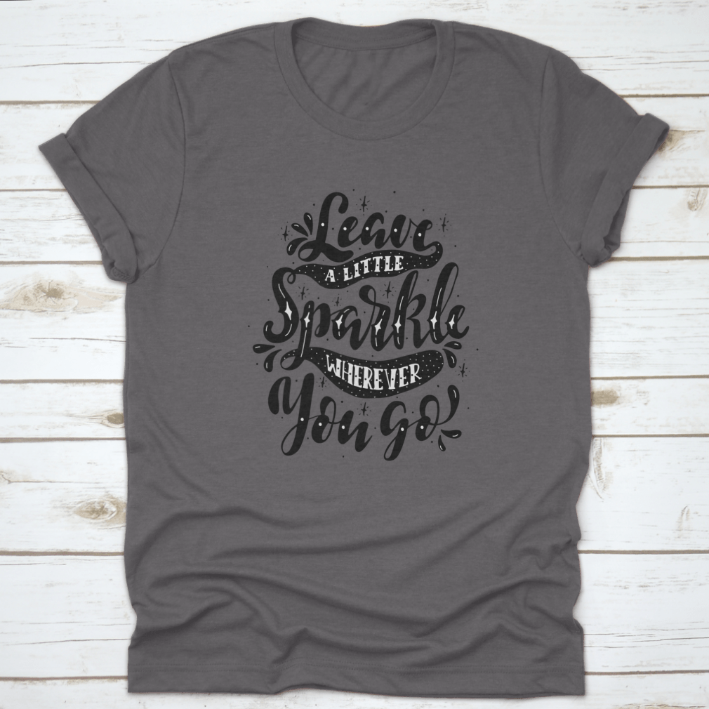 A comfortable and stylish t-shirt featuring the inspirational phrase 'Leave A Little Sparkle Wherever You Go' in a vibrant print.