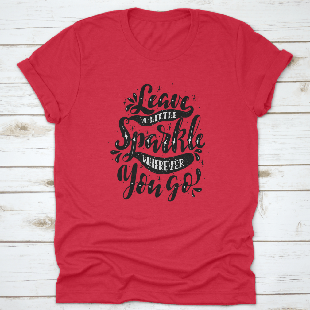 A comfortable and stylish t-shirt featuring the inspirational phrase 'Leave A Little Sparkle Wherever You Go' in a vibrant print.